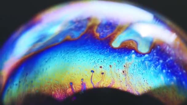 Abstract multicolored chaotic swirl texture inside of the soap bubble, closeup — Stock Video