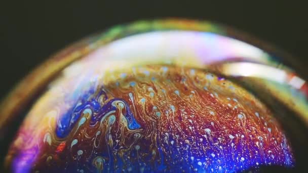 Abstract multicolored chaotic swirl texture inside of the soap bubble, closeup — Stock Video