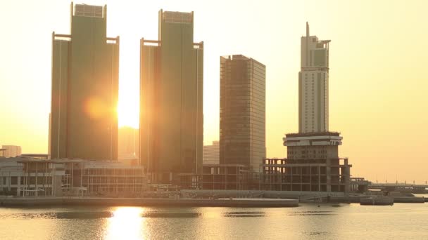 Východ slunce na ostrově Al Reem v Abu Dhabi, město. Siluety vysokých moderních budov, za nimiž vychází slunce. — Stock video