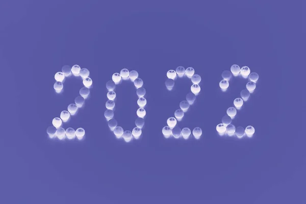 Year 2022 laid out from white round shapes candies on trendy very peri color background — Stockfoto