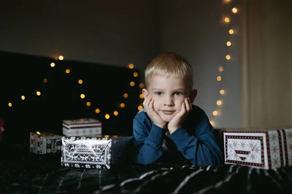 Søt Liten Gutt Pyjamas Liggende Sengen Omgitt Julegaver Som Venter – stockfoto