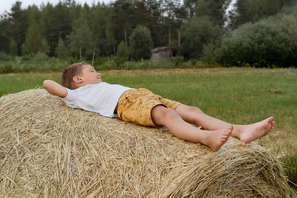 Little Boy Laying Haysack Straw His Mouth High Quality Photo — 图库照片