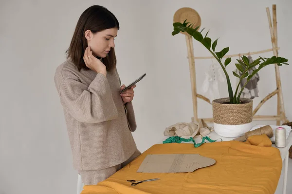 Young Attractive Designer Works Phone Front Table Spread Out Fabric — Stockfoto