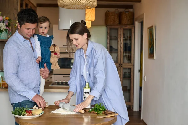 お父さんのお母さんと娘がキッチンで一緒にピザを作ってる 幸せな家庭の概念 — ストック写真