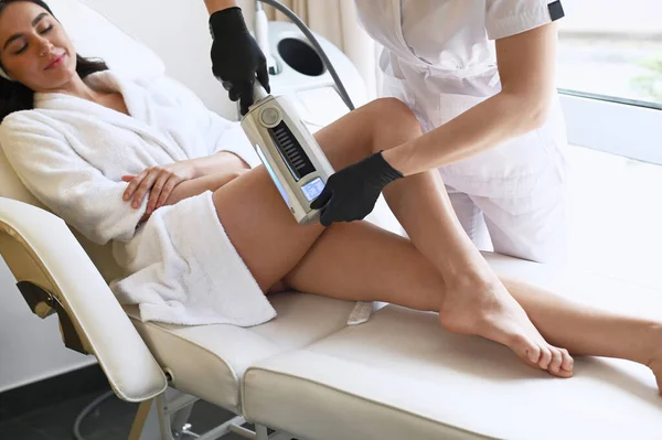 Beautiful woman enjoys buttocks massage with endosphere machine for anti-cellulite and body correction