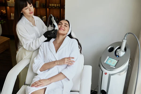 Beautiful woman enjoys buttocks massage with endosphere machine for anti-cellulite and body correction