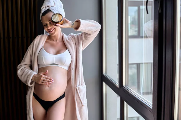 Beautiful Pregnant Woman Bathrobe Applies Cream Her Belly Window Morning — Foto Stock