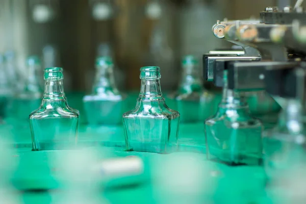 Пляшки з напоєм закриті гвинтовою кришкою. Завод з виробництва алкогольних напоїв — стокове фото