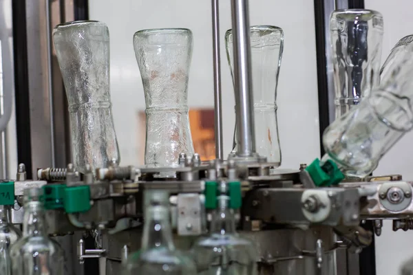 Stock image The machine for washing glass bottles. Factory for bottling alcoholic beverages.