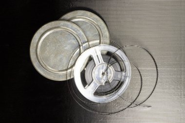 Siyah beyaz film stokları ve siyah arka planda kutuları olan eski makaralar