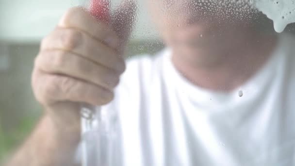 Man Washing Cleaning Window Home Using Cleanser Spray Disinfectant Foam — Stock Video