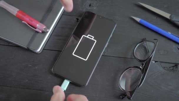 Charging Smartphone Lying Black Wooden Table Connecting Usb Cable Phone — Wideo stockowe