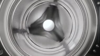 Spinning washing machine drum that stops. Close up