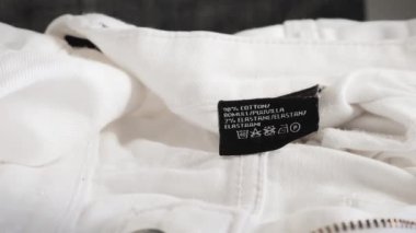 Clothing washing instructions label. Close up on black label.