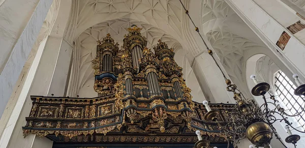Gdansk, Poland - August  9: Antique gilded musical organ in the medieval Church of the Virgin Mary in Gdansk, Poland. 