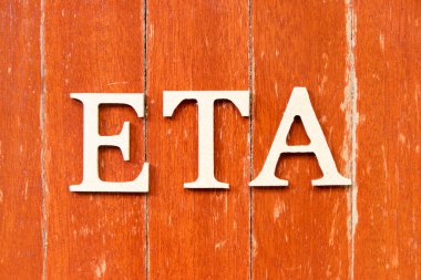 Eski kırmızı tahta arka plan üzerinde ETA (tahmini varış zamanının kısaltması) kelimesindeki alfabe harfi