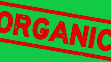 Grunge kırmızı organik kelime yeşil arka planda lastik damga yakınlaştırma