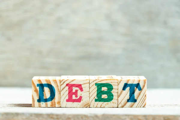 Alphabet Buchstabenblock Wort Schulden Auf Holz Hintergrund — Stockfoto