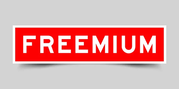 Etiqueta Engomada Con Palabra Freemium Color Rojo Sobre Fondo Gris — Vector de stock