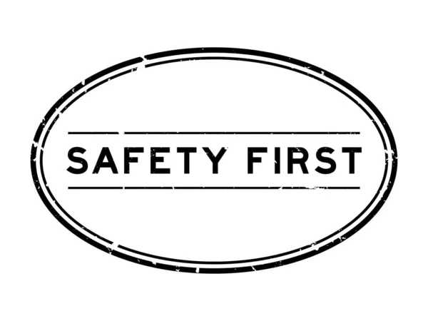 Grunge Black Safety First Word Oval Rubber Seal Stamp White — Stock Vector