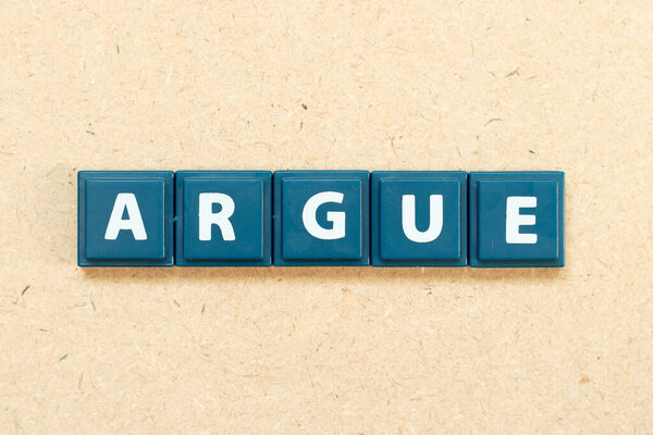 Tile alphabet letter in word argue on wood background