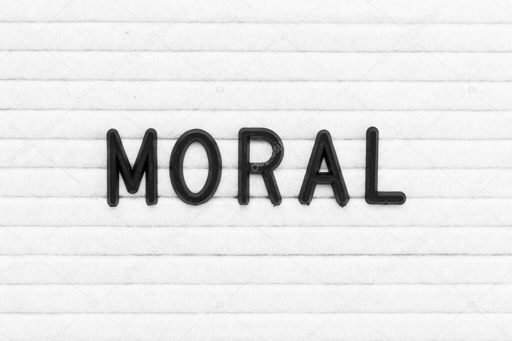 Black color letter in word moral on white felt board background