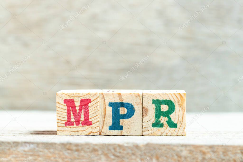 Alphabet letter block in word MPR (Abbreviation of Market price referent or Monthly progress report) on wood background