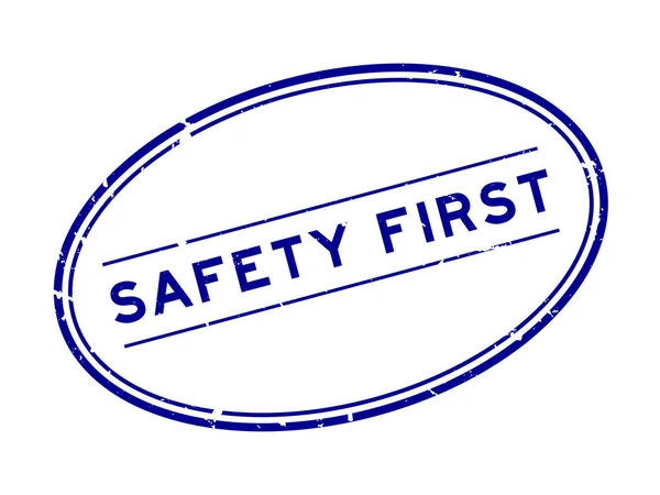 Grunge Blue Safety First Word Oval Rubber Seal Stamp White — Stock Vector