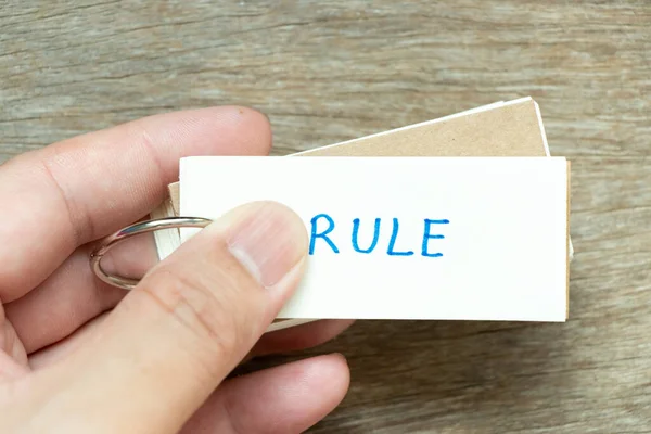 Man Hold Flash Card Handwriting Word Rule Wood Background — Fotografia de Stock