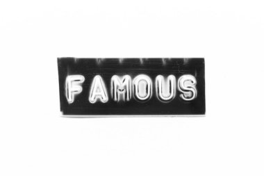Black color banner that have embossed letter with word famous on white paper background