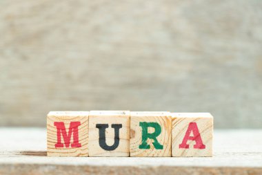 Alphabet letter block in word mura on wood background