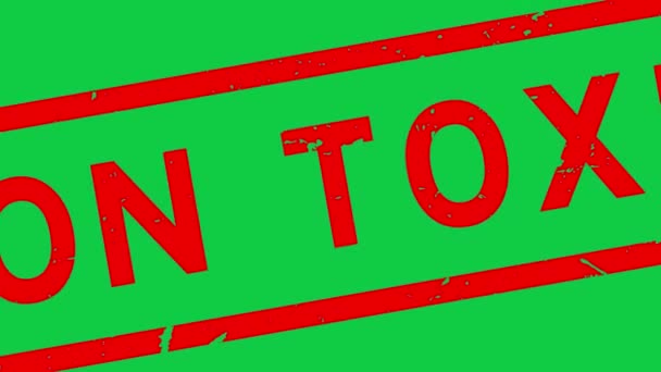 緑の背景からグランジ赤非毒性単語正方形のゴムシールスタンプZoonアウト — ストック動画