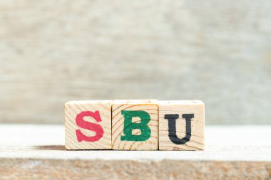 Tahta zemin üzerinde SBU (Stratejik iş biriminin kısaltması) kelimesindeki alfabe harf bloğu