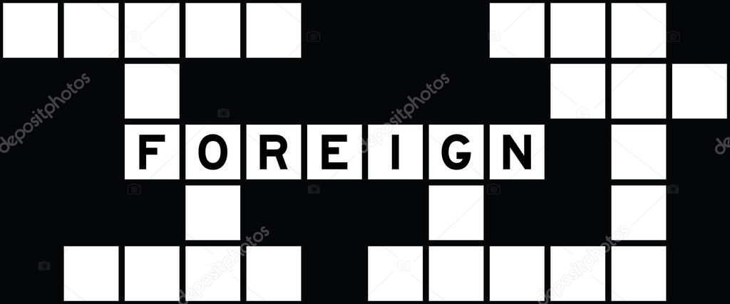 Alphabet letter in word foreign on crossword puzzle background