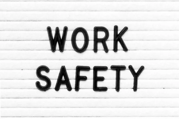 Black Color Letter Word Work Safety White Felt Board Background — Stockfoto