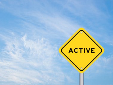 Yellow transportation sign with word active on blue sky background