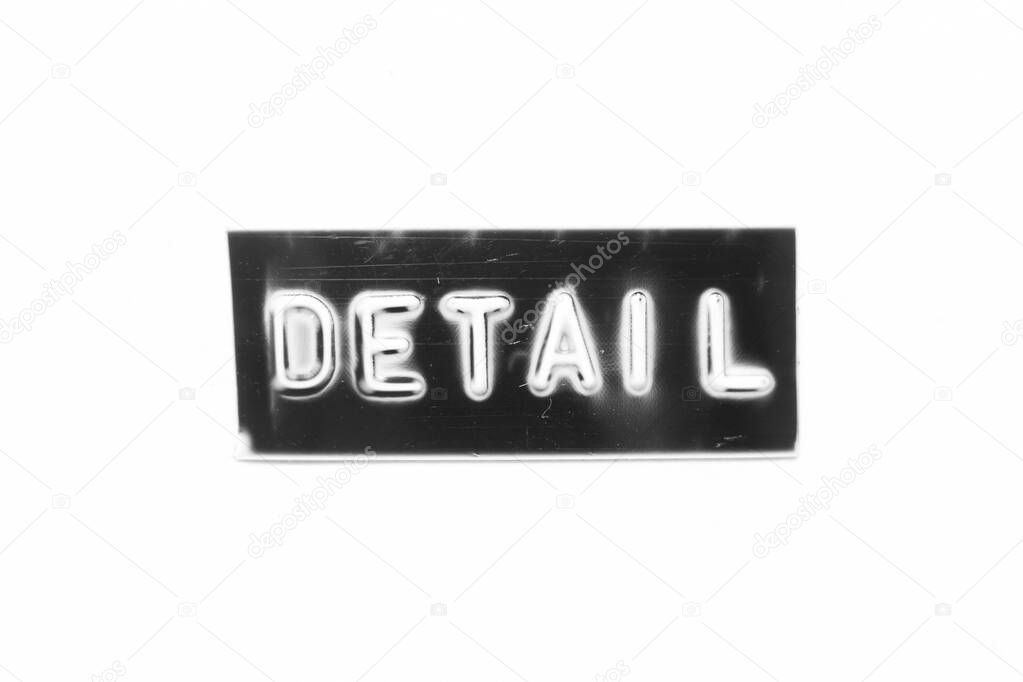 Black color banner that have embossed letter with word detail on white paper background