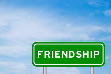 Green color transportation sign with word friendship on blue sky with white cloud background