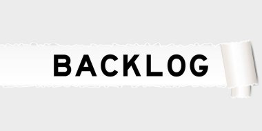 Ripped gray paper background that have word backlog under torn part