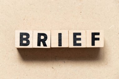 Alphabet letter block in word brief on wood background