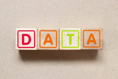 Color letter block in word data on wood background