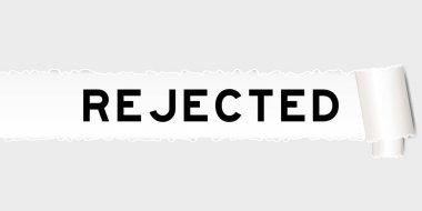 Ripped gray paper background that have word rejected under torn part