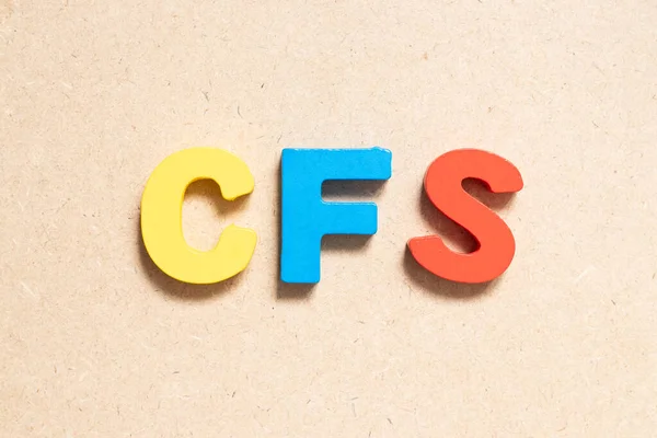 Color alphabet letter in word CFS (Abbreviation of Container Freight Station, Certified fund specialist or Chronic fatigue syndrome) on wood background