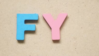 Man hold wood letter I to complete english word FYI (Abbreviation of For your information)