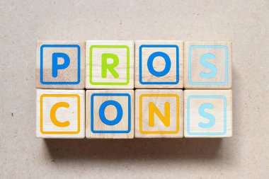 Color letter block in word pros cons on wood background