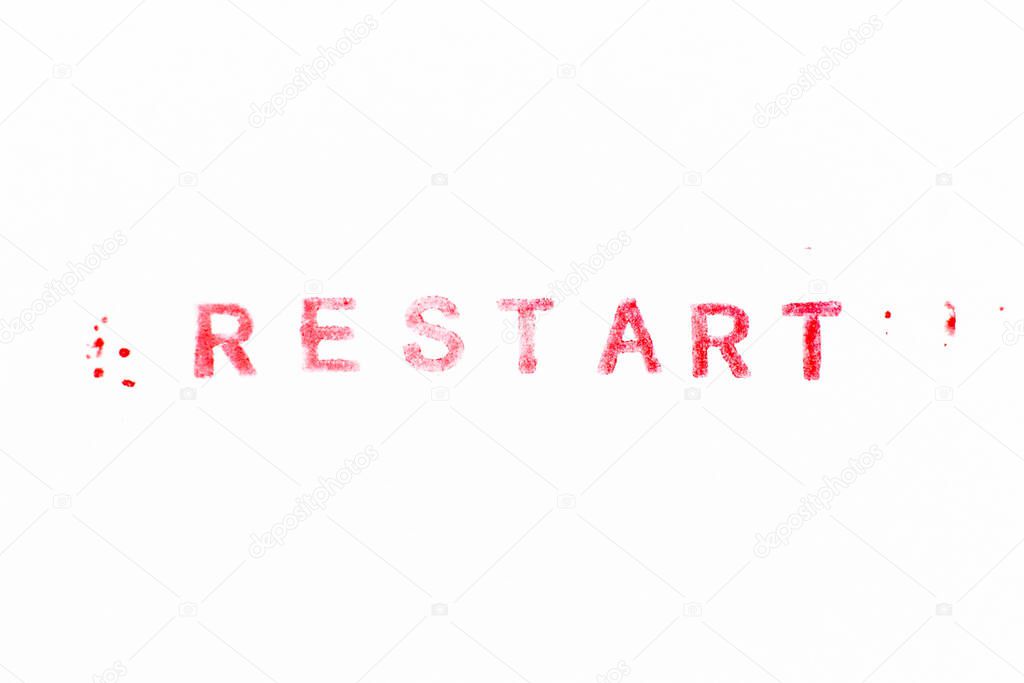 Red color ink rubber stamp in word restart on white paper background