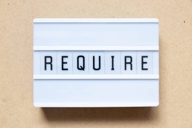 Lightbox with word require on wood background