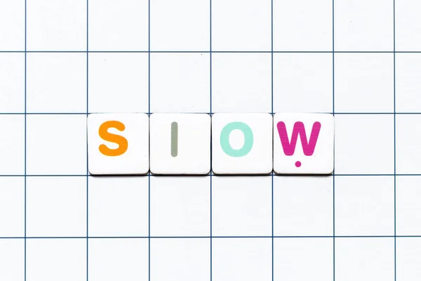 Colorful Tile Letter Word Slow White Grid Background — kuvapankkivalokuva