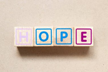 Color letter block in word hope on wood background
