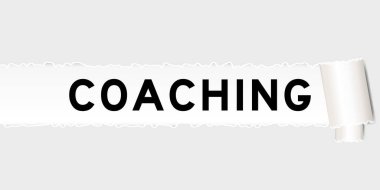 Ripped gray paper background that have word coaching under torn part